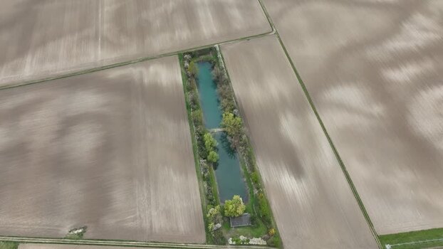 Aerial view of water canal and agricultural fields France.
