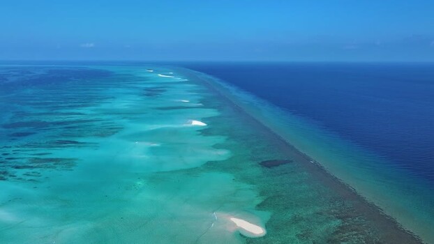Aerial view of a coral reef and turquoise lagoon in Maldives. Aerial view of a coral reef and turquoise lagoon in Maldives.
