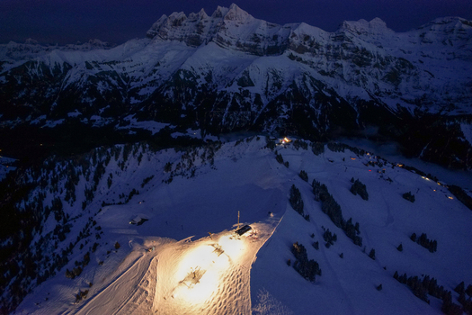 Aerial view of Les Crosets ski resort and the Dents du Midi mountain range under a twilight sky with illuminated slopes in Val d Illiez Valais Switzerland. Aerial view of Les Crosets ski resort and the Dents du Midi mountain range under a twilight sky with illuminated slopes in Val d Illiez Valais Switzerland.