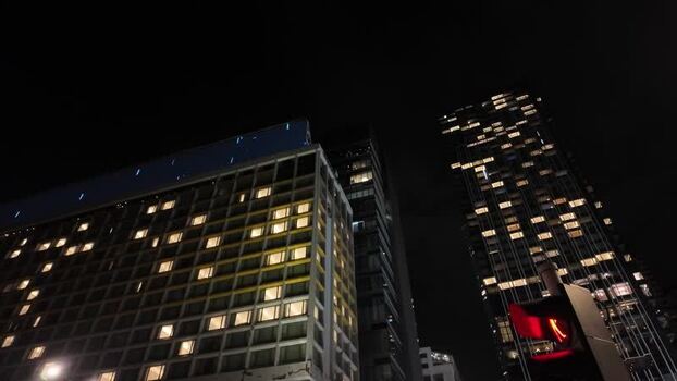 View of illuminated skyscrapers at night in Hong Kong.