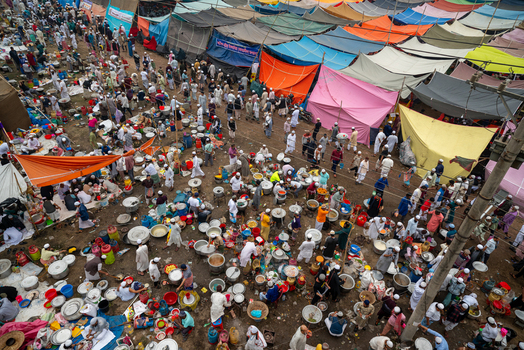 Tongi Bangladesh 31 January 2025 Aerial view of Tongi Ijtema Maidan with numerous colorful tents and large crowds of people preparing food in large pots.