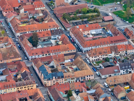 Aerial view of the symmetrical layout and red tiled roofs create a warm textured tapestry across the urban landscape Neuf Brisach Grand Est France.