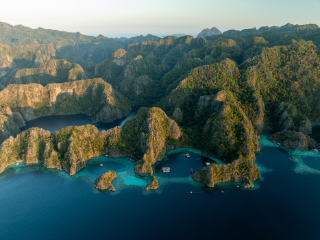 Aerial view of Twin Lagoon featuring turquoise waters limestone cliffs and lush vegetation in Coron Mimaropa Philippines. Aerial view of Twin Lagoon featuring turquoise waters limestone cliffs and lush vegetation in Coron Mimaropa Philippines.