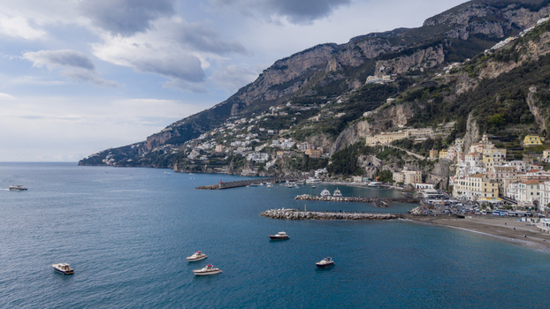 Aerial view of the Amalfi Coast s quaint buildings cascading down the cliffs towards the turquoise sea Amalfi Italy. Aerial view of the Amalfi Coast s quaint buildings cascading down the cliffs towards the turquoise sea Amalfi Italy.