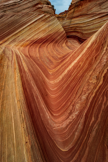 View of the undulating sandstone formations of The Wave with colorful orange and red stripes in the desert landscape of Kanab Arizona United States. View of the undulating sandstone formations of The Wave with colorful orange and red stripes in the desert landscape of Kanab Arizona United States.