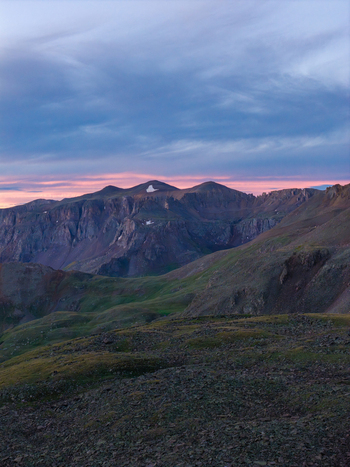 Aerial view of Mount Sneffels in the San Juan Mountain Range at sunset featuring rugged alpine peaks rocky slopes and dramatic clouds over Ouray Colorado United States. Aerial view of Mount Sneffels in the San Juan Mountain Range at sunset featuring rugged alpine peaks rocky slopes and dramatic clouds over Ouray Colorado United States.