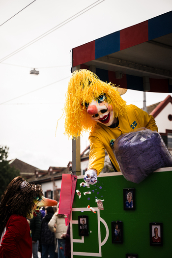 Basel Switzerland 10 March 2025 View of a vibrant Fasnacht celebration with a masked figure in yellow tossing confetti from a decorated float. Basel Switzerland 10 March 2025 View of a vibrant Fasnacht celebration with a masked figure in yellow tossing confetti from a decorated float.