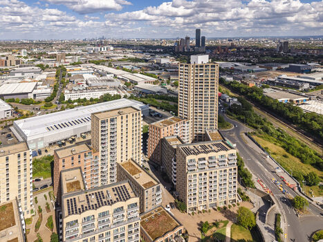 Aerial view of modern residential apartment buildings at Lakeside Drive featuring green roofs and solar panels surrounded by urban infrastructure in London England United Kingdom. Aerial view of modern residential apartment buildings at Lakeside Drive featuring green roofs and solar panels surrounded by urban infrastructure in London England United Kingdom.