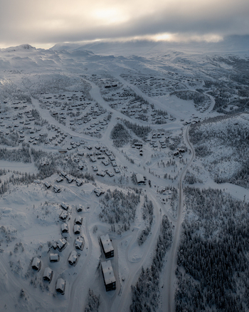 Aerial view of Gaustablikk Fjellresort surrounded by snow covered cabins and ski slopes in the winter landscape of Rjukan Telemark Norway. Aerial view of Gaustablikk Fjellresort surrounded by snow covered cabins and ski slopes in the winter landscape of Rjukan Telemark Norway.