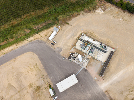Aerial view of a modern biomethane production facility with bioCNG and bioLNG fueling station featuring industrial equipment and storage tanks in Tavazzano con Villavesco Lombardy Italy.