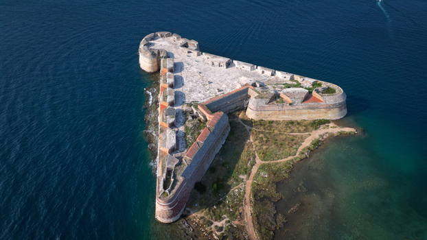Aerial view of St. Nicholas Fortress a triangular stone fortification surrounded by the deep blue waters of the Adriatic Sea in Sibenik Croatia.
