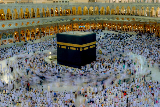 Aerial view of the Kaaba at Masjid al Haram with crowds of pilgrims circling the sacred structure in Makkah Makkah Province Saudi Arabia. Aerial view of the Kaaba at Masjid al Haram with crowds of pilgrims circling the sacred structure in Makkah Makkah Province Saudi Arabia.