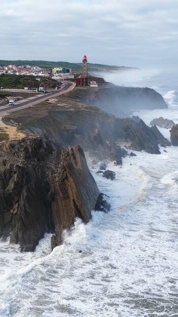 Aerial view of Farol Penedo da Saudade on rugged cliffs Portugal. Aerial view of Farol Penedo da Saudade on rugged cliffs Portugal.