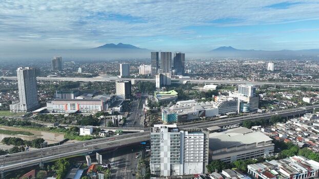Bekasi Barat West Java Indonesia 12 April 2026 Aerial view of the urban landscape featuring high rise buildings highway infrastructure and residential neighborhoods under a clear sky. Bekasi Barat West Java Indonesia 12 April 2026 Aerial view of the urban landscape featuring high rise buildings highway infrastructure and residential neighborhoods under a clear sky.