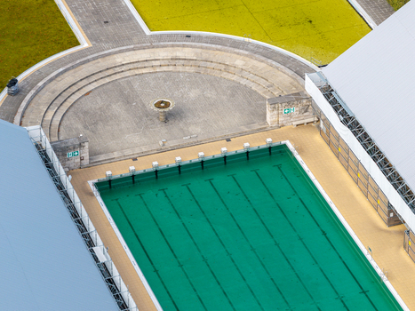 Berlin Germany 26 September 2026 Aerial view of the swimming pool at the Olympiastadion Berlin featuring green water lane markers and a semi circular stone patio area.