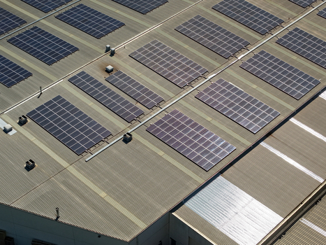 Aerial view of solar panels installed on the corrugated metal roof of an industrial factory building in Kilsyth Victoria Australia. Aerial view of solar panels installed on the corrugated metal roof of an industrial factory building in Kilsyth Victoria Australia.