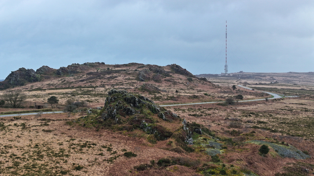 Aerial view of Roc h Trevezel peak with its rocky outcrops overlooking the Monts d Arree moorland and a distant radio mast in Plouneour Menez Brittany France.