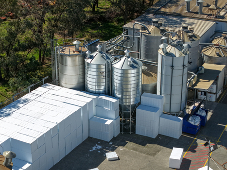Kilsyth Victoria Australia 20 September 2026 Aerial view of industrial silos and stacks of white polystyrene blocks at a manufacturing facility. Kilsyth Victoria Australia 20 September 2026 Aerial view of industrial silos and stacks of white polystyrene blocks at a manufacturing facility.
