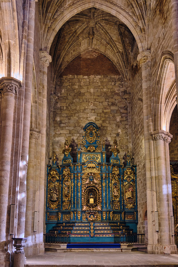 Plasencia Spain 03 December 2025 View of the ornate blue and gold altarpiece inside the Catedral Nueva de Plasencia with stone walls and vaulted ceiling. Plasencia Spain 03 December 2025 View of the ornate blue and gold altarpiece inside the Catedral Nueva de Plasencia with stone walls and vaulted ceiling.