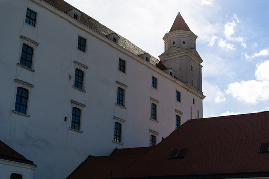 View of the historic Bratislava Castle with its white facade and corner tower under a bright sky in Bratislava Bratislava Region Slovakia. View of the historic Bratislava Castle with its white facade and corner tower under a bright sky in Bratislava Bratislava Region Slovakia.