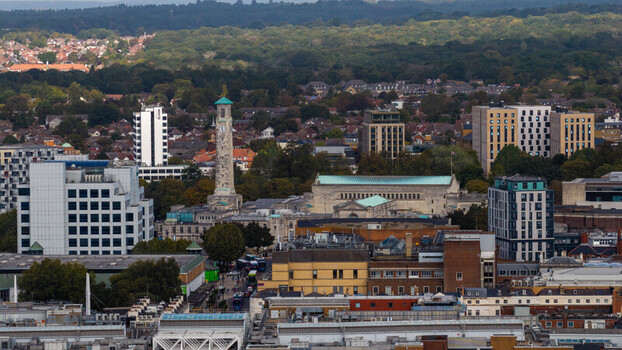 Aerial view of the historic Civic Centre clock tower surrounded by modern buildings and dense urban landscape in Southampton England United Kingdom. Aerial view of the historic Civic Centre clock tower surrounded by modern buildings and dense urban landscape in Southampton England United Kingdom.