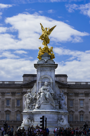 London United Kingdom 10 May 2019 View of the Victoria Memorial with its golden statue and marble sculptures set against the facade of Buckingham Palace under a blue sky. London United Kingdom 10 May 2019 View of the Victoria Memorial with its golden statue and marble sculptures set against the facade of Buckingham Palace under a blue sky.