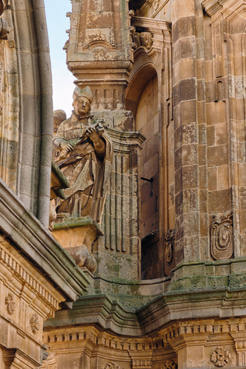 Salamanca Spain 01 December 2025 View of the ornate baroque facade of the Pontifical University of Salamanca featuring a religious stone statue and intricate architectural carvings. Salamanca Spain 01 December 2025 View of the ornate baroque facade of the Pontifical University of Salamanca featuring a religious stone statue and intricate architectural carvings.