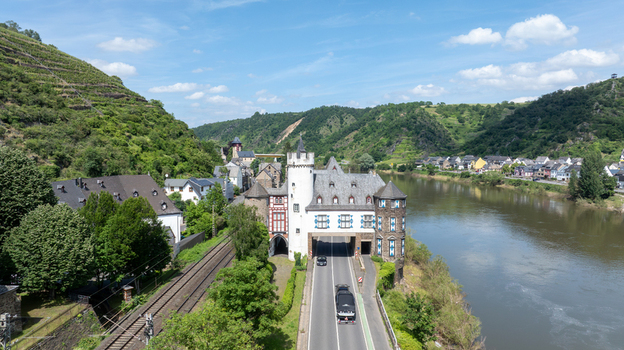 Aerial view of the historic castle complex with a road passage nestled between lush vineyards and the Moselle river valley in Kobern Gondorf Rheinland Pfalz Germany. Aerial view of the historic castle complex with a road passage nestled between lush vineyards and the Moselle river valley in Kobern Gondorf Rheinland Pfalz Germany.