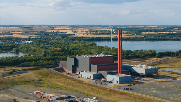 Aerial view of Rookery South ERF energy recovery facility featuring a tall red chimney industrial buildings and surrounding landscape with a lake in Stewartby England United Kingdom. Aerial view of Rookery South ERF energy recovery facility featuring a tall red chimney industrial buildings and surrounding landscape with a lake in Stewartby England United Kingdom.