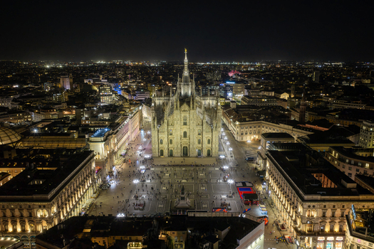 Milan Italy 23 September 2026 Aerial view of Milan Cathedral illuminated at night surrounded by the bustling Piazza del Duomo and the historic city skyline. Milan Italy 23 September 2026 Aerial view of Milan Cathedral illuminated at night surrounded by the bustling Piazza del Duomo and the historic city skyline.