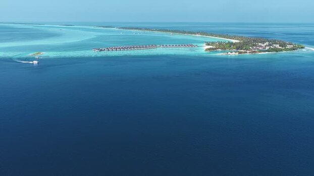 Aerial view of a tropical island resort and lagoon Maldives. Aerial view of a tropical island resort and lagoon Maldives.