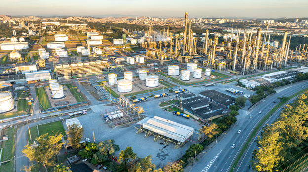 Aerial view of the petrochemical complex featuring storage tanks industrial towers and pipelines near a highway in Santo Andre State of Sao Paulo Brazil.