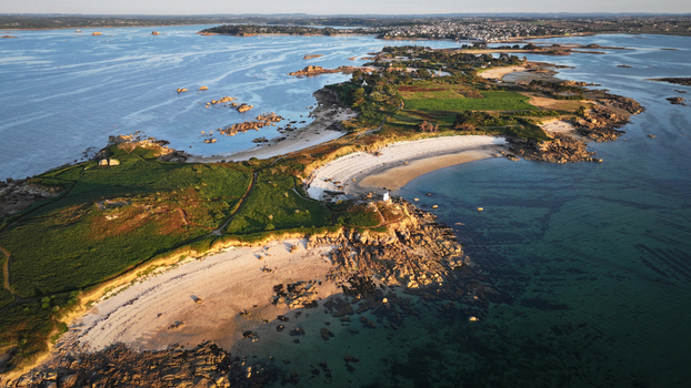 Aerial view of the rugged coastline meeting the serene turquoise waters around the Île Callot with rocky outcrops and sandy beaches Carantec Brittany France. Aerial view of the rugged coastline meeting the serene turquoise waters around the Île Callot with rocky outcrops and sandy beaches Carantec Brittany France.