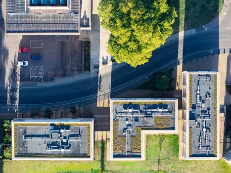 Aerial view of the Data Center at Oxford University featuring industrial rooftop HVAC systems green roof sections and surrounding urban infrastructure in Oxford England United Kingdom. Aerial view of the Data Center at Oxford University featuring industrial rooftop HVAC systems green roof sections and surrounding urban infrastructure in Oxford England United Kingdom.