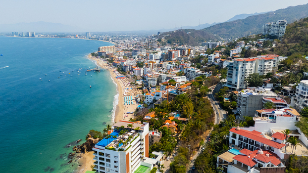 Aerial view of the vibrant coastline where the city meets the sea a tapestry of buildings cascading down to the sandy beaches Puerto Vallarta Jalisco Mexico.
