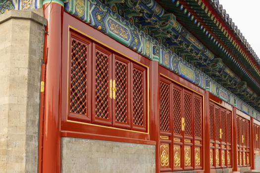 View of the ornate red lattice windows and colorful painted eaves of the Forbidden City imperial palace Beijing Beijing China. View of the ornate red lattice windows and colorful painted eaves of the Forbidden City imperial palace Beijing Beijing China.