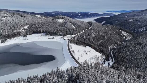 Aerial view of Soboth Reservoir and snowy forests Austria. Aerial view of Soboth Reservoir and snowy forests Austria.