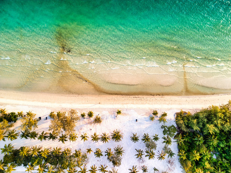 Aerial view of the serene beach meeting the lush tropical forest a captivating blend of turquoise waters and verdant greens Preah Sihanouk Sihanoukville Cambodia.