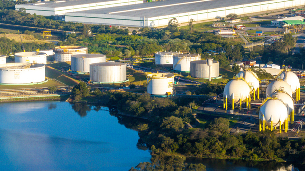 Aerial view of the Capuava Petrochemical Complex with large storage tanks spherical gas containers and industrial buildings situated near a lake in Santo Andre State of Sao Paulo Brazil.