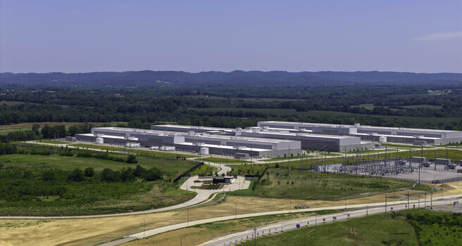 Aerial view of the Meta Data Center featuring large industrial buildings surrounding green fields and an electrical substation in Gallatin Tennessee United States. Aerial view of the Meta Data Center featuring large industrial buildings surrounding green fields and an electrical substation in Gallatin Tennessee United States.