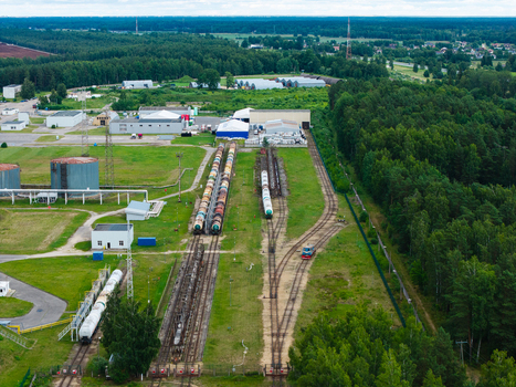 Olaine parish Olaine Municipality Latvia 04 July 2026 Aerial view of the industrial rail yard featuring rows of tanker cars storage tanks and surrounding forest landscape. Olaine parish Olaine Municipality Latvia 04 July 2026 Aerial view of the industrial rail yard featuring rows of tanker cars storage tanks and surrounding forest landscape.