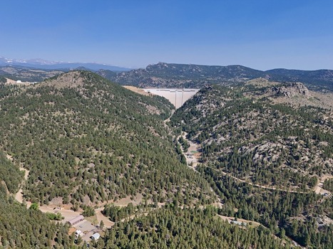 Aerial view of the Gross Reservoir Dam nestled within the pine covered mountains of the Rocky Mountain foothills Golden Colorado United States. Aerial view of the Gross Reservoir Dam nestled within the pine covered mountains of the Rocky Mountain foothills Golden Colorado United States.