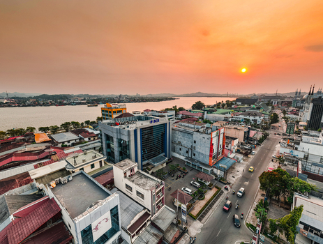 Samarinda Indonesia 21 September 2026 Aerial view of BCA KCU Samarinda bank building along the Mahakam River at sunset with urban rooftops and city traffic. Samarinda Indonesia 21 September 2026 Aerial view of BCA KCU Samarinda bank building along the Mahakam River at sunset with urban rooftops and city traffic.