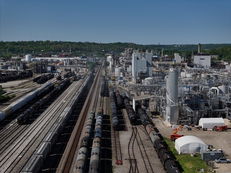Aerial view of an industrial chemical plant and a large rail yard with freight tanker cars Cincinnati OH United States. Aerial view of an industrial chemical plant and a large rail yard with freight tanker cars Cincinnati OH United States.