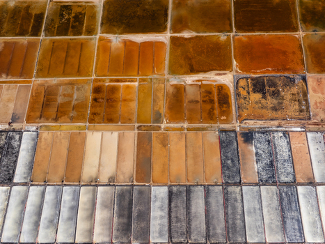 Aerial view of salt pans in Vietnam showing rectangular plots with varying shades of brown white and grey indicating different stages of salt production. Aerial view of salt pans in Vietnam showing rectangular plots with varying shades of brown white and grey indicating different stages of salt production.