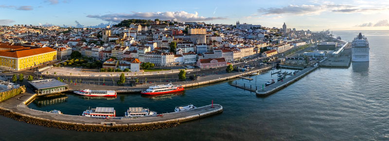 Aerial view of Lisbon Cruise Port Jardim do Tabaco Quay and the historic city skyline along the Tagus River under a soft golden light Lisboa Lisboa Portugal.
