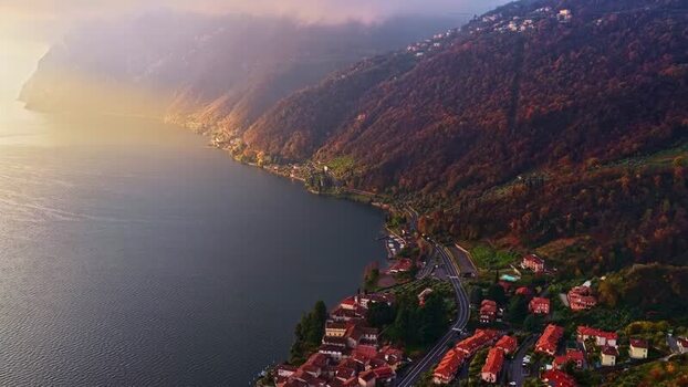 Aerial view of coastal town and lake in Italy.