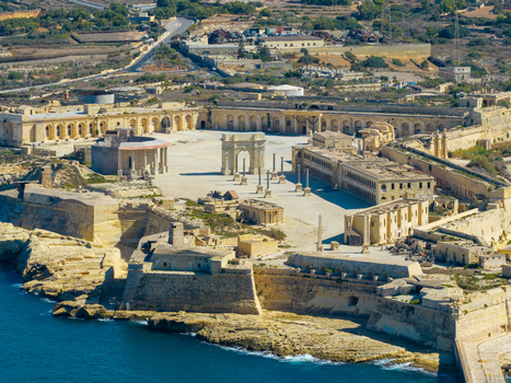 Aerial view of Fort Manoel with its historic stone fortifications central square and archway overlooking the sea in Valletta Port Region Malta. Aerial view of Fort Manoel with its historic stone fortifications central square and archway overlooking the sea in Valletta Port Region Malta.