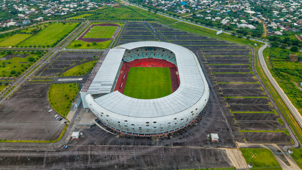 Aerial view of Godswill Akpabio Stadium with its distinctive oval architecture green pitch and surrounding parking lots in Uyo Akwa Ibom Nigeria. Aerial view of Godswill Akpabio Stadium with its distinctive oval architecture green pitch and surrounding parking lots in Uyo Akwa Ibom Nigeria.