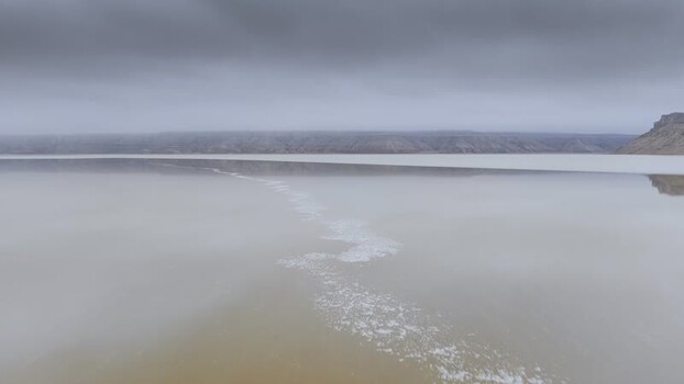 Aerial view of Karynzharyk salt flat and distant cliffs Kazakhstan. Aerial view of Karynzharyk salt flat and distant cliffs Kazakhstan.